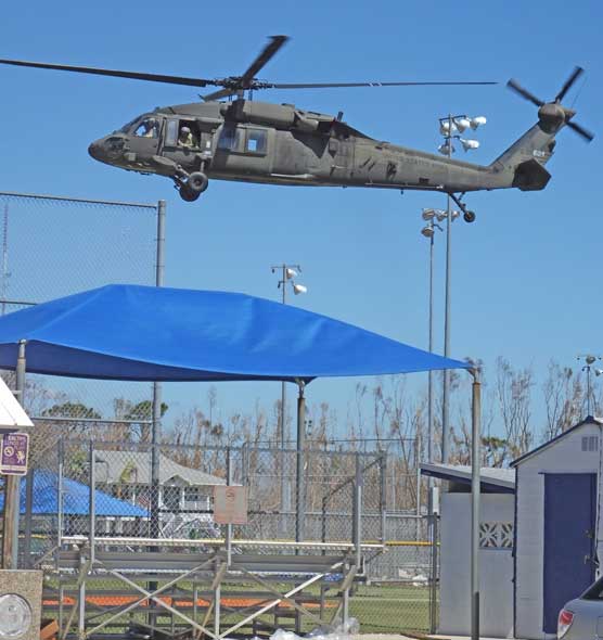National Guard bringing supplies to the baseball field at Pine Island Center. Access to Pine Island was washed out and cut off